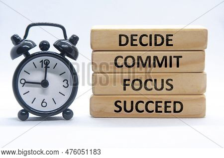 Decide, Commit, Focus, Succeed Text On Wooden Blocks With Alarm Clock On White Cover Background.