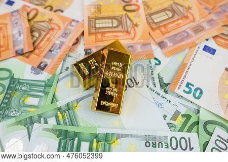 Euro Banknotes And Gold Bars. Gold Bars On Money