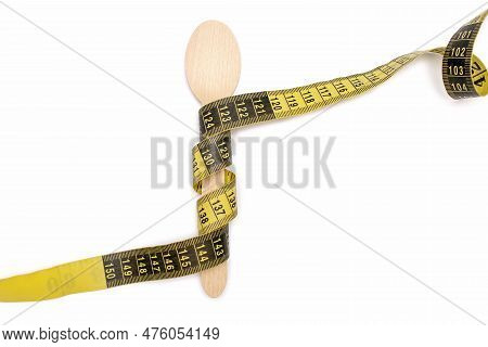 Wooden Spoon And Measuring Tape On A White Isolated Background. The Concept Of Diet And Weight Loss.