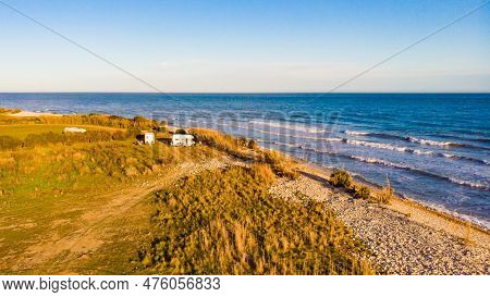 Aerial View. Coastal Landscape With Caravan Wild Camping On Beach Sea Shore. Mediterranean Coast Of 