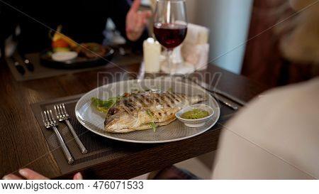 The Waiter Puts Delicious Dishes On The Table. The Waiter Puts Delicious Dishes On The Table. The Wa