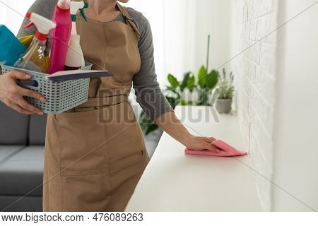 Young Woman Doing House Chores. Woman Holding Cleaning Tools. Woman Wearing Rubber Protective Yellow