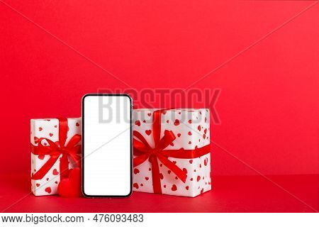 Mobile Phone With Blank Screen On Colored Background With Hearts, Calendar And Gift Box, Valentine D