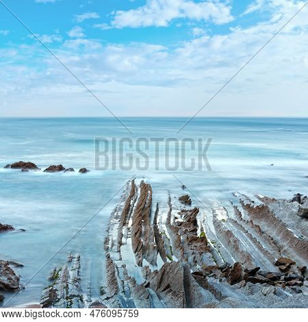 Twilight Ocean Coast With Ribbed Stratiform Rock Formations. (atlantic Ocean, Spain).