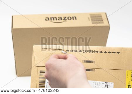 Fuji City, Shizuoka-ken, Japan - March 26, 2023: Hand Opening Delivery Envelope With Cardboard Box W
