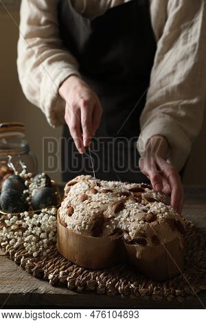 Woman Cutting Delicious Italian Easter Dove Cake (traditional Colomba Di Pasqua) At Wooden Table, Cl