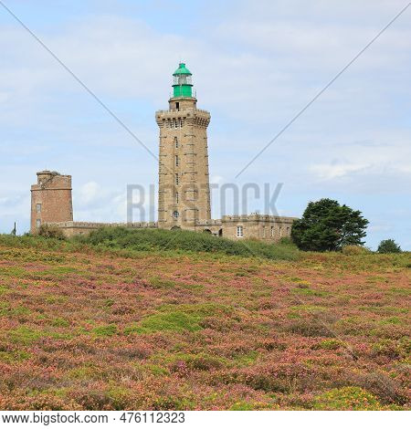 Lighthouse And Colorful Flowers At Cap Frehel, Brittany. Travel Destination At The French Coast.