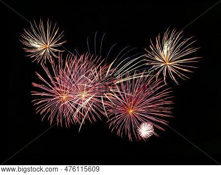 Multiple Fireworks Against The Deep Black Sky. Bright  Display Of The Fireworks