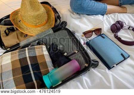 Close Up Of Clothes And Other Posessions On The Bed