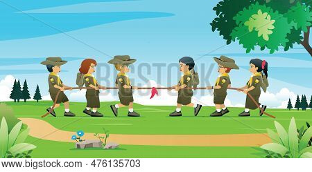 Students In Scout Uniforms Are Tug Of War In A Nature Park.