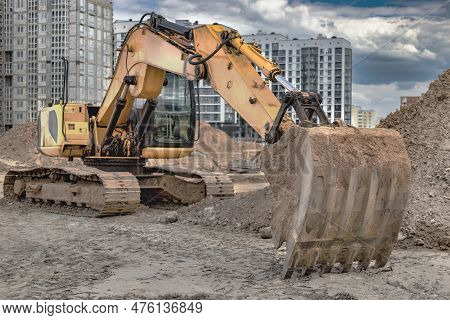 Crawler Excavator Machine Unloading Sand Or Soil At Construction Area Background. Close-up Of An Exc
