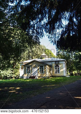 An Old Wooden Yellow House In The Old Slavic Style. Around The Natural Forest. Summer Day. Walkway I