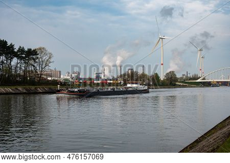 Geel, Antwerp Province, Belgium - April 22, 2023 -  Industrial Activity And Cargo Ship At The Canal