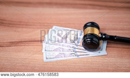 The Gavel On A Dollar Bill In A Courtroom Represents The Complex Interplay Between Alimony Law, Alim