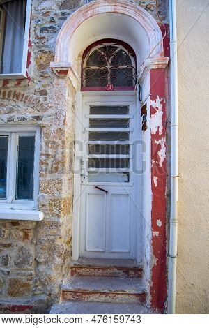 A White Narrow Door In A Turkish House With An Arch And A Window. Concept Architecture And Landmarks