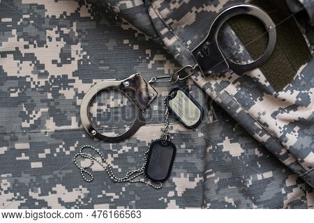 A Military Camouflage, Handcuffed. Concept: War Criminal, Prisoner Of War, Tribunal For Deserters, T