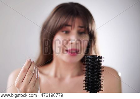 Hairfall And Hairloss. Worried Woman With Hair Loss