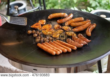 Meat Balls, Hot Dogs And Other Meats On A Large Hot Plate