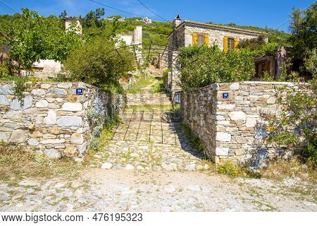 Stone Turkish Fence Next To The House On A Sunny And Summer Day.