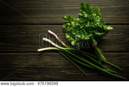 A Bunch Of Green Fresh Fragrant Parsley And Green Onions On A Dark Kitchen Table Before Adding To Fo