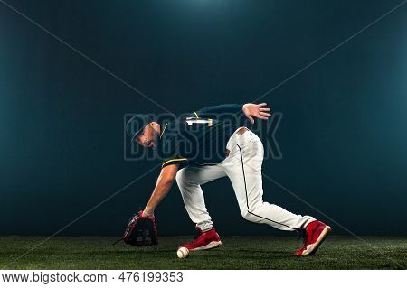 Baseball Player On Dark Background. Ballplayer Portrait.