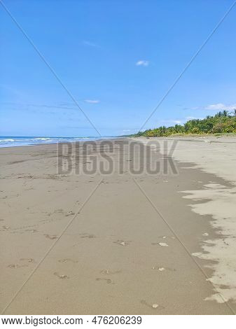 Long Sandy Beach By The Pacific In Costa Rica.