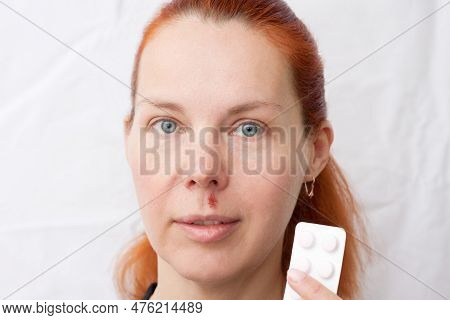 Portrait Of Middle Aged Woman With Herpes Above Upper Lip, On Light Background. Woman Holding Pills 