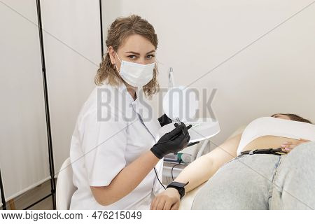 Cosmetologist Doing Hair Removal Procedure With Electrolysis On Hand Of White Young Patient, Electro