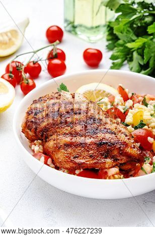 Grilled Chicken Fillet With Bulgur Tabbouleh Salad With Colorful Tomatoes, Parsley And Lemon Dressin