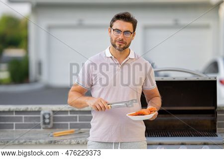 Cook Man Preparing Barbecue Grill Outdoor. Man Cooking Tasty Food On Barbecue Grill At Backyard. Che