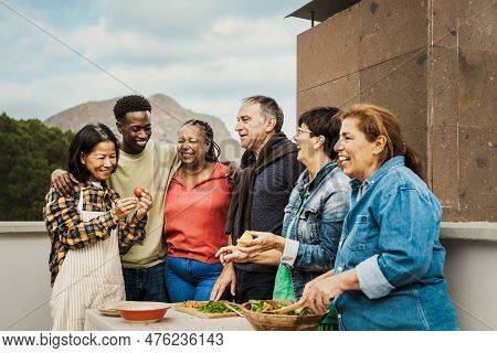 Multi Generational Friends Having Fun Cooking Together At House Rooftop - Summer Gatherings And Food
