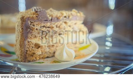 Cakes And Cupcakes In The Window Behind The Glass Slowly Rotate