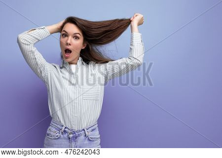 Charming Young Brunette Female Adult With Chic Silky Healthy Hair Below Her Shoulders In A Studio Ba