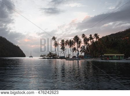 Tropical Sandy Beach With Palm Trees In Turquoise Lagoon In The Caribbean Islands, Sailboats Anchori
