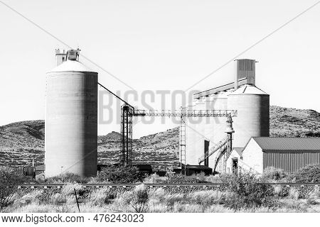Prieska, South Africa - Mar 1, 2023: Grain Silos In Prieska In The Northern Cape Province. A Railway