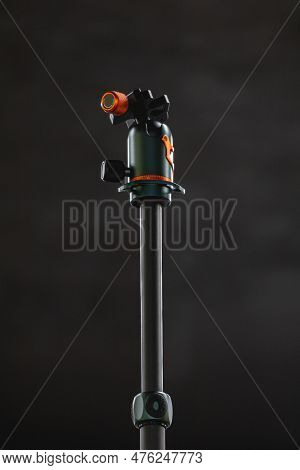 Gray Central Column Of Photo Tripod With Green And Orange Ballhead On Top