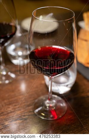 Dinner With Glass Of Dry Red Wine In Italian Osteria Restaurant