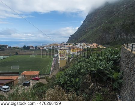 View Of Old Village Agulo With Colorful Traditional Houses, Terraced Fields, Green Field And Mountai