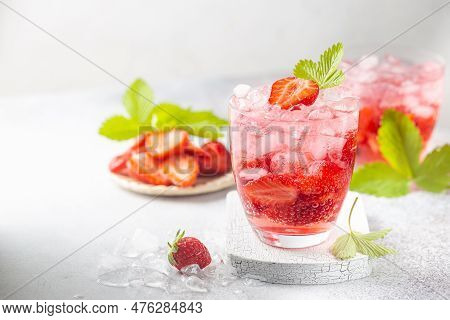 Refreshing Summer Drink With Strawberry Slices In Glasses On White Background