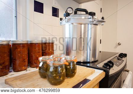 Home Canning Jalapenos In Jars And A Batch Of Chili With A Pressure Cooker. Food Preservation Is Key