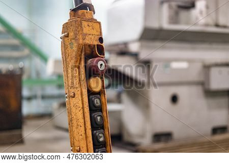 A Worker Is Operating Remote Swtich To Control Overhead Crane At The Factory Warehouse. Industrial W