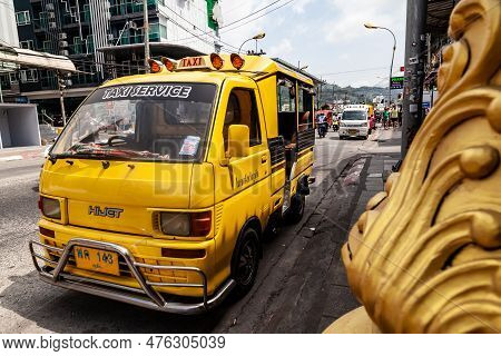 Thailand, Patong - 03.27.23: Small Japanese Trucks Converted Into Taxis For Tourists Called Tuk Tuk 