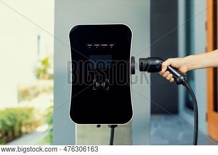 Closeup Hand Insert Ev Charger Plug, Green Energy-powered Charging Point Concept For Ev Car Connecte