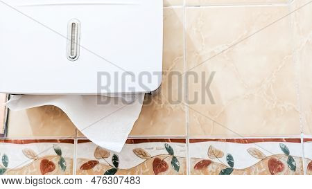 A Modern Plastic Kleenex Dispenser on the Tiled Wall. Close-up with little depth of field. Hygienes Life Concept