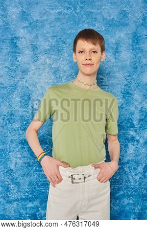Young Queer Person In Casual Clothes Holding Hands In Pockets Of Pants And Looking At Camera During 
