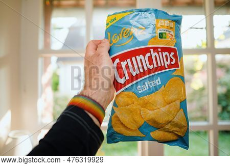 Paris, France - May 2, 2023: A Mans Hand Holds A Bag Of Lorenz Salted Crunchips, Ready To Enjoy Thei
