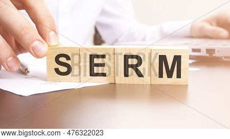 Man Made Text Serm With Wood Blocks On The Background Of The Office Table. Selective Focus. Business