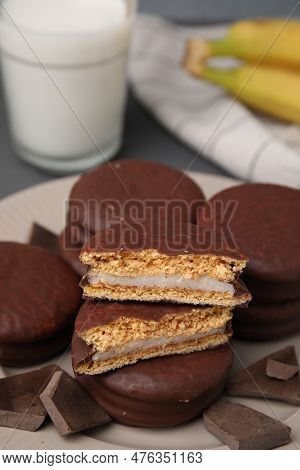 Tasty Banana Choco Pies And Pieces Of Chocolate On Plate, Closeup. Space For Text