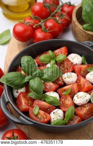 Tasty Salad Caprese With Mozarella Balls, Tomatoes And Basil On Table, Above View