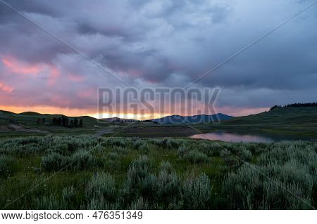Sun Fades Behind Thick Clouds At Sunet In Hayden Valley In Yellowstone